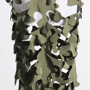 Detail of army green laser-cut camouflage skirt showing wavy layered hollow pattern
