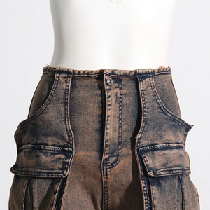 Detail of high-waisted cargo pants with heavy acid wash texture and large flap pockets