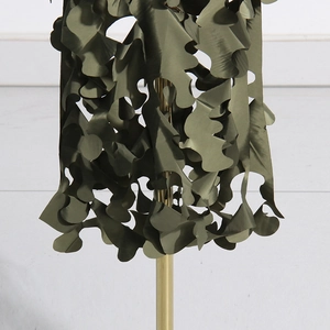 Detail of 3D leaf-cut army green camouflage netting with wave-like texture for concealment