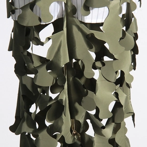 Close-up of army green laser-cut leaf pattern on an irregular hollowed patchwork skirt