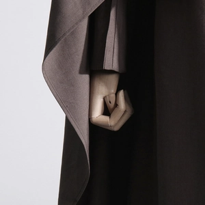 Close-up of bronze textured fabric on a stylish slim-fit long blazer for women