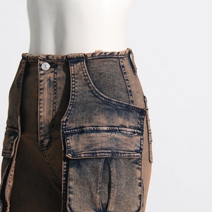 Close-up of high waist acid washed cargo jeans with side pockets and metal buttons