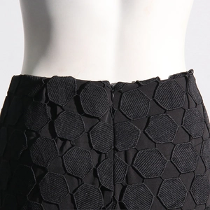 Detail of high waist trousers featuring hexagonal texture fabric and invisible back zipper