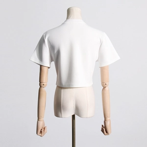 Rear view of white crop top t-shirt showing minimalist cut and round neck details on a mannequin