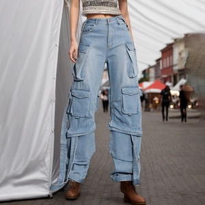 Detail view of light blue cargo denim pants featuring multi-pocket straps and street style