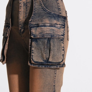 Detail of acid wash cargo jeans featuring dual-tone gradient and 3D flap pockets
