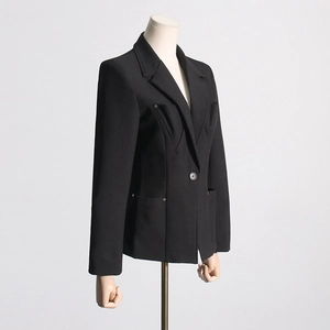 Detail of black slim-fit blazer with pleated chest design and rivet pocket accents
