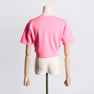 Rear view of pink cropped T-shirt with split hem on a wooden mannequin stand