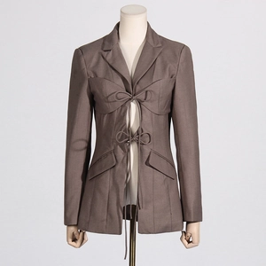 Detail of a chic dark taupe blazer featuring unique double bow ties and a cinched waist design