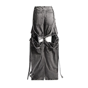 Detail of dark grey washed denim cargo pants with hollow-out back cut and long ribbon ties
