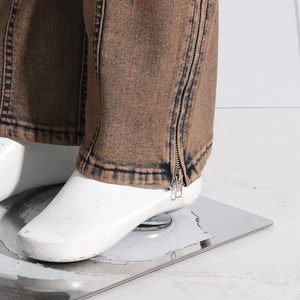 Detail shot of the adjustable metal zipper on the hem of acid wash cargo pants