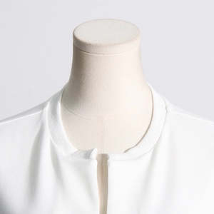 Close-up of white knit T-shirt neckline with premium ribbed texture and minimalist design