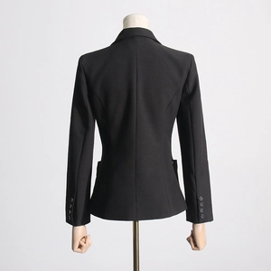 Back view of a slim-fit black blazer featuring decorative buttons on the sleeve cuffs