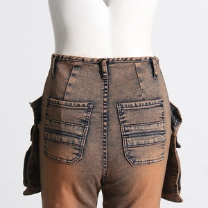 Detail view of high-waist acid wash cargo jeans with large side utility pockets