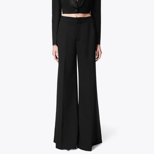 Detail of high-waist straight-leg trousers with side diamond trim and premium fabric texture
