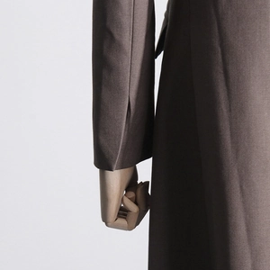Detailed close-up of brown satin blazer sleeve and side cut, featuring premium glossy texture