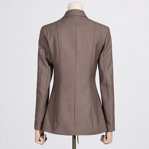 Detail view of the back seams and slim waistline on a dark brown tailored blazer
