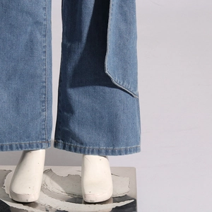 Détail du tissu denim bleu clair avec gros plan sur les finitions à double couture renforcée