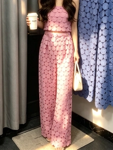 Pink two-piece set with tube top and high waist hollow wide leg pants with round textures