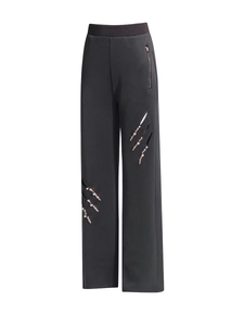 Damenhose mit weitem Bein in Schwarz, Cut-outs und Strass-Knochen-Verzierungen