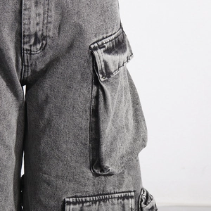 Close-up of the large flap cargo pocket and acid wash texture on these denim pants
