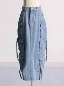 Washed light blue denim cargo skirt with multiple utility pockets and long drawstrings