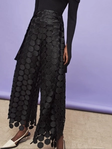 Fashionable high waist black wide leg pants featuring unique sequin embroidery and cutouts
