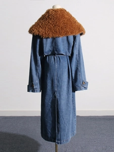 Long blue denim coat for women featuring a large brown faux fur collar and waist tie