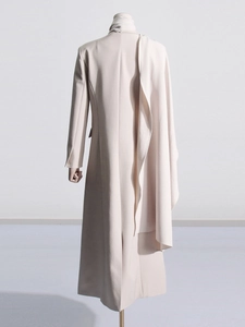 Minimalist beige long blazer coat with unique cape back design on mannequin