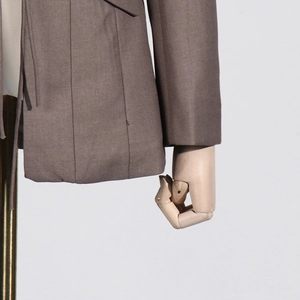 Detailed close-up of brown blazer hem and cuff showing twill fabric texture on a mannequin