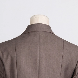 Detail of tailored taupe blazer showing rear seam and high-quality shoulder stitching