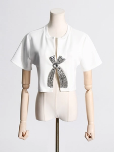 White short sleeve T-shirt with large rhinestone bow and pearl embellishment on mannequin
