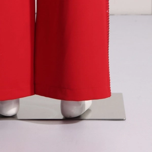 Detail of high-waist straight trousers featuring sparkling rhinestone side trim and red fabric