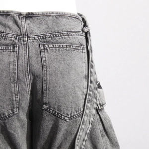Close-up of vintage washed dark gray denim cargo pants with large side pockets