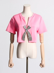 Pink short sleeve top featuring a large rhinestone bow with pearl accents and center gem