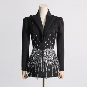 Detail of sequin and crystal fringe on the hem of a black sequined tuxedo dress