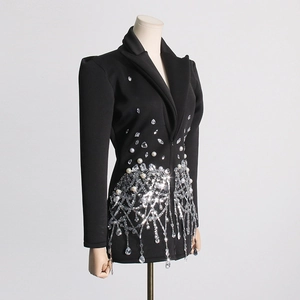 Detail of V-neck suit dress featuring intricate rhinestone and sequin tassel fringe decor