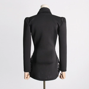 Detail view of the back of a black mini dress with shimmering silver sequin side panels