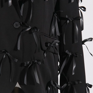 Detailed view of black satin bows on stylish V-neck long sleeve blazer jacket