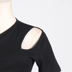 Detail of a black one-shoulder top showing clean hollowed-out shoulder design and knit texture