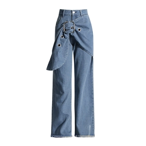 Detail of high-waist jeans with a large silver buckle, metal eyelets, and frayed hem