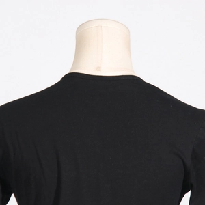 Close-up of the back neckline and shoulder stitching on this black off-shoulder t-shirt