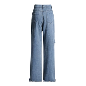 Detail view of high waist light blue wide leg jeans with dual back pockets and raw hem edges