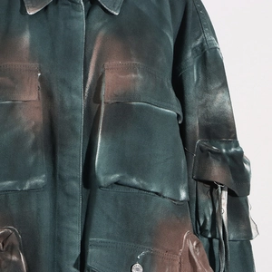 Detail view of retro military style denim jacket with cargo pockets and washed finish