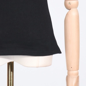 Detail of the black T-shirt hem showing high-quality double-needle stitching and fabric
