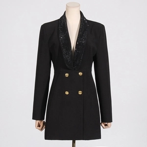 Dettaglio dell'abito blazer nero con risvolto di paillettes e bottoni dorati in rilievo