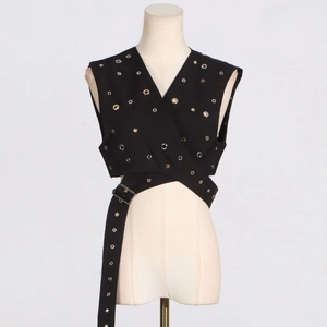 Detail of black sleeveless wrap vest featuring silver metal eyelets and buckled waist belt