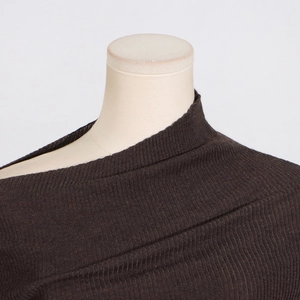 Detailed view of dark brown ribbed knit fabric texture and asymmetrical off-shoulder neckline
