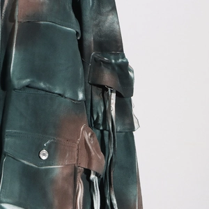 Detail of vintage cargo jacket featuring camo tie-dye fabric and heavy utility pockets