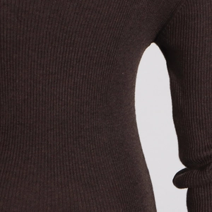 Macro detail of dark brown ribbed knit fabric texture on slim-fit long sleeve dress